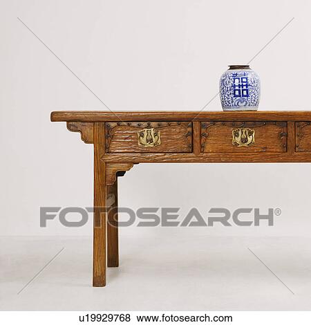 Decorative urn on a wooden desk View Large Photo Image Stock Photo - Decorative urn on a wooden desk. Fotosearch