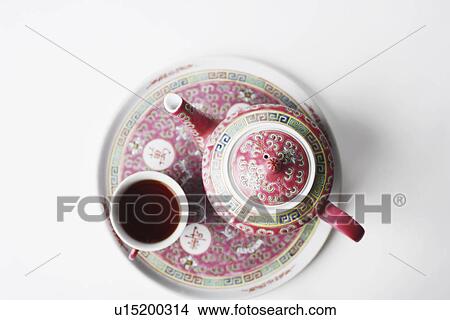 High angle view of a cup of black tea and a teapot on a tray View Large Photo Image Picture - High angle view of a cup of black tea and a teapot on a tray. Fotosearch