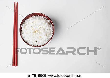 High angle view of a pair of chopsticks near a bowl of rice View Large Photo Image Stock Photograph - High angle view of a pair of chopsticks near a bowl of rice. Fotosearch
