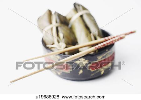 High angle view of food in a bowl with a pair of chopsticks View Large Photo Image Stock Photo - High angle view of food in a bowl with a pair of chopsticks. Fotosearch