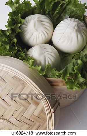Stock Photo - High angle view of steamed dumplings in a steamer. Fotosearch