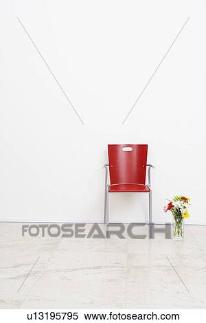 Stock Photography - Office chair and a vase in an office. Fotosearch