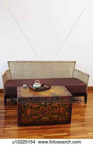 Picture - Teapot and a tea cup with a tray on a trunk. Fotosearch