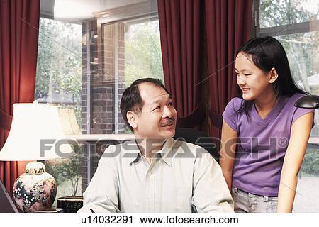 Stock Image - Close-up of a father talking to his daughter. Fotosearch