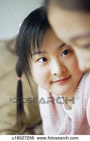 Stock Photograph - Close-up of two sisters. Fotosearch