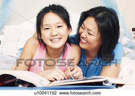 Stock Image - Mother and her daughter smiling. Fotosearch
