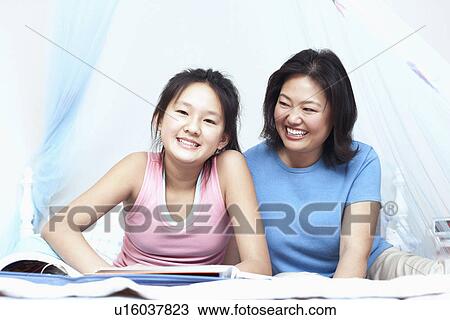 Stock Image - Mother and her daughter smiling. Fotosearch