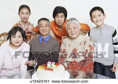 Stock Image - Portrait of a family at a birthday party. Fotosearch