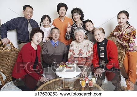Stock Image - Portrait of a family at a birthday party. Fotosearch