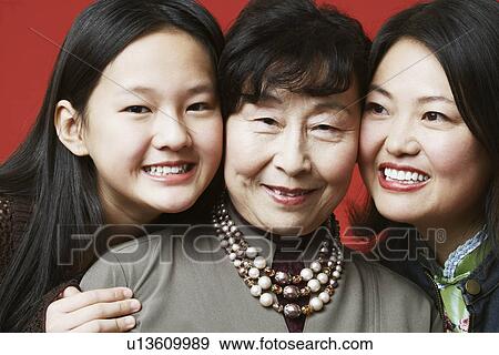 Stock Photo - Portrait of a grandmother and her granddaughter smiling. Fotosearch