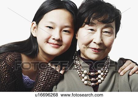 Portrait of a grandmother and her granddaughter smiling View Large Photo Image Stock Photo - Portrait of a grandmother and her granddaughter smiling. Fotosearch