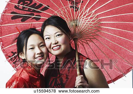Stock Photo - Portrait of a mother and her daughter smiling. Fotosearch
