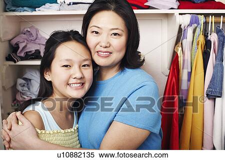 Stock Photography - Portrait of a mother hugging her daughter. Fotosearch