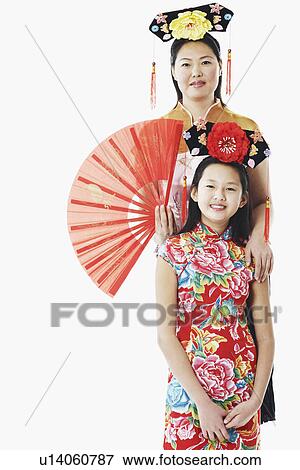 Stock Photo - Portrait of a mother standing behind her daughter. Fotosearch