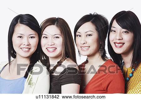 Stock Image - Portrait of four young women smiling. Fotosearch