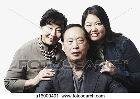 Stock Image - Portrait of parents with their daughter smiling. Fotosearch