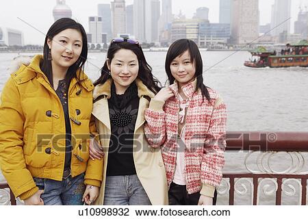 Portrait of three young women smiling View Large Photo Image Stock Image - Portrait of three young women smiling. Fotosearch