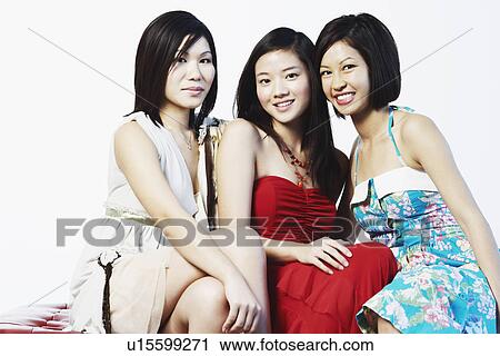 Stock Image - Portrait of three young women smiling. Fotosearch