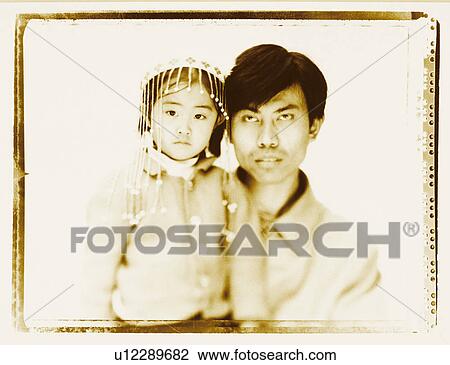 Stock Image - Close-up of a father carrying his daughter. Fotosearch