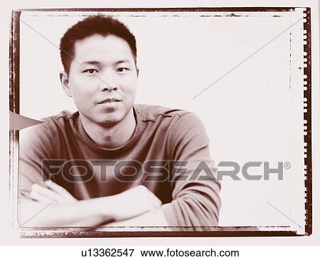 Stock Photo - Portrait of a young man grinning. Fotosearch