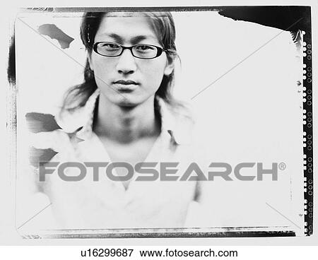 Portrait of a young man wearing eyeglasses View Large Photo Image Stock Photo - Portrait of a young man wearing eyeglasses. Fotosearch