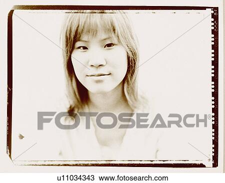 Stock Image - Portrait of a young woman grinning. Fotosearch