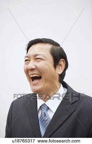 Stock Photo - Close-up of a businessman laughing. Fotosearch