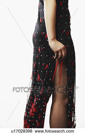 Mid section view of a young woman holding chopsticks View Large Photo Image Stock Photo - Mid section view of a young woman holding chopsticks. Fotosearch