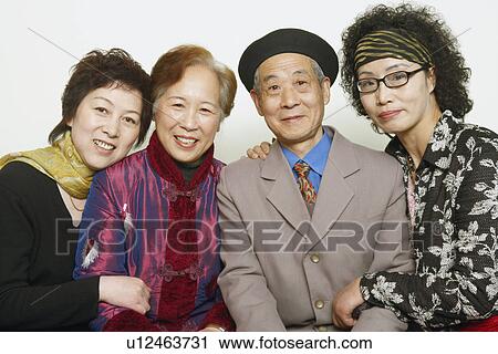 Stock Image - Portrait of a senior man sitting with three mature women. Fotosearch