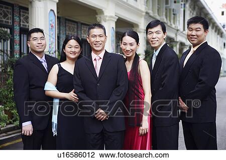 Stock Image - Portrait of four businessmen and two businesswomen standing. Fotosearch