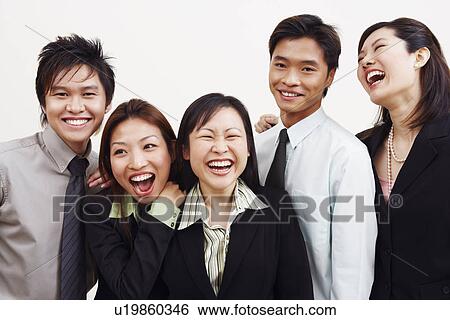Stock Photograph - Portrait of three businesswomen and two businessmen smiling. Fotosearch