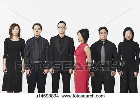 Picture - Portrait of three young men and three young women looking serious. Fotosearch