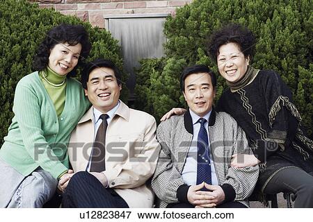 Portrait of two mature couples sitting together smiling View Large Photo Image Stock Photo - Portrait of two mature couples sitting together smiling. Fotosearch