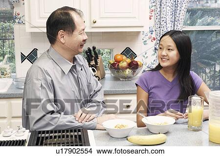Close-up of a father and his daughter in the kitchen View Large Photo Image Picture - Close-up of a father and his daughter in the kitchen. Fotosearch