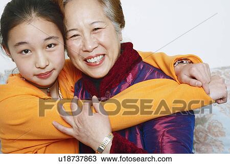 Portrait of a daughter hugging her mother View Large Photo Image Stock Image - Portrait of a daughter hugging her mother. Fotosearch