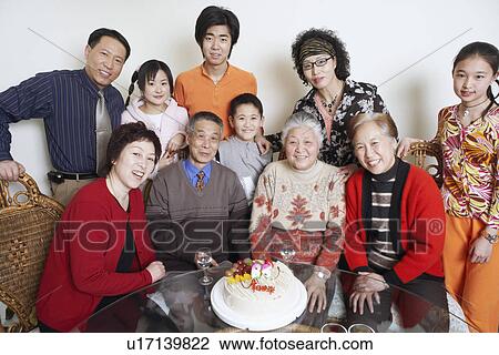 Stock Image - Portrait of a family at a birthday party. Fotosearch