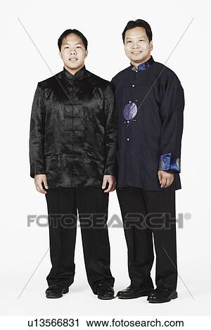 Stock Image - Portrait of a father and his son standing. Fotosearch