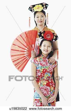 Portrait of a mother standing behind her daughter View Large Photo Image Stock Image - Portrait of a mother standing behind her daughter. Fotosearch