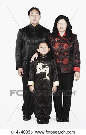 Stock Photography - Portrait of a mother standing with her two sons smiling. Fotosearch
