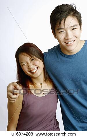 Portrait of a young couple smiling and standing together View Large Photo Image Stock Photo - Portrait of a young couple smiling and standing together. Fotosearch