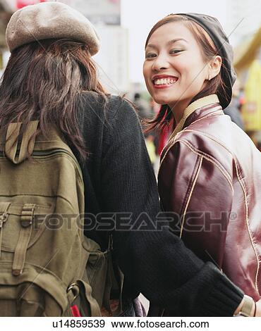 Stock Photo - Portrait of a young woman looking back. Fotosearch