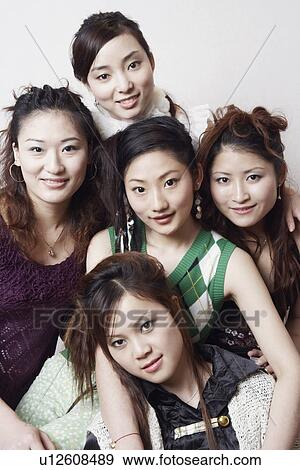 Stock Photo - Portrait of three young women and a teenage girl. Fotosearch