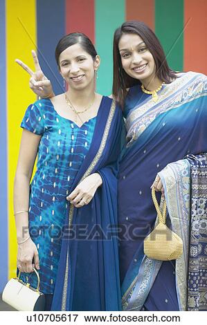 Stock Photo - Portrait of two women standing beside each other. Fotosearch
