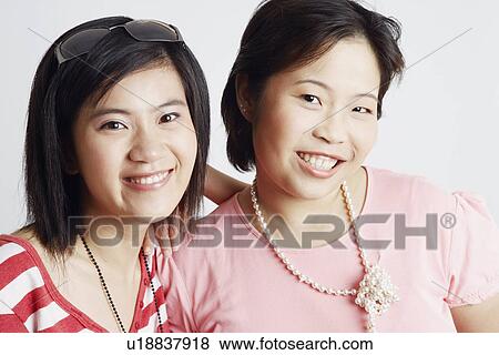 Portrait of two young women smiling View Large Photo Image Stock Photo - Portrait of two young women smiling. Fotosearch