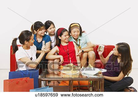 Young woman celebrating her birthday with her friends View Large Photo Image Stock Photo - Young woman celebrating her birthday with her friends. Fotosearch