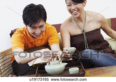 Close-up of a young couple with a kettle and coffee cups View Large Photo Image Stock Photography - Close-up of a young couple with a kettle and coffee cups. Fotosearch