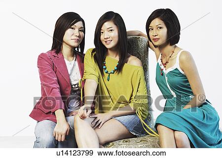 Portrait of three young women posing View Large Photo Image Stock Photo - Portrait of three young women posing. Fotosearch