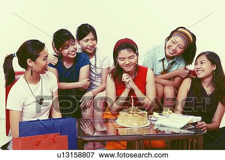 Stock Photo - Group of young women at a birthday party. Fotosearch