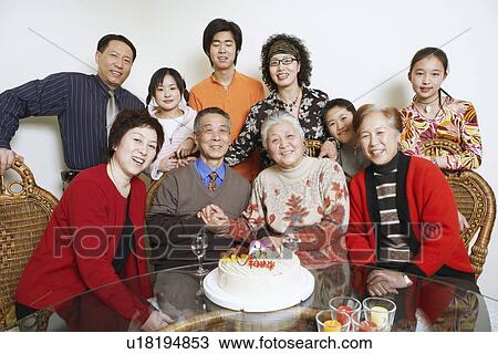 Stock Image - Portrait of a family at a birthday party. Fotosearch