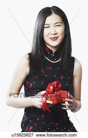Stock Photo - Portrait of a young woman holding a gift. Fotosearch